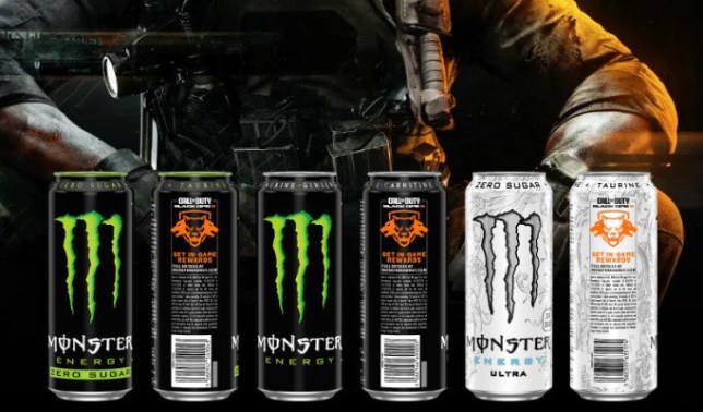 A row of different Monster energy drinks with a Black Ops 6 character in the background.