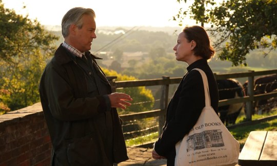 A scene from The Burning Girls showing Reverend Jack speaking to a man in a park.