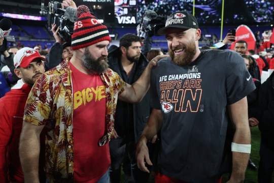 Travis Kelce and Jason Kelce smile on football field