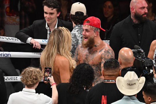 Paul celebrates with his girlfriend in the ring