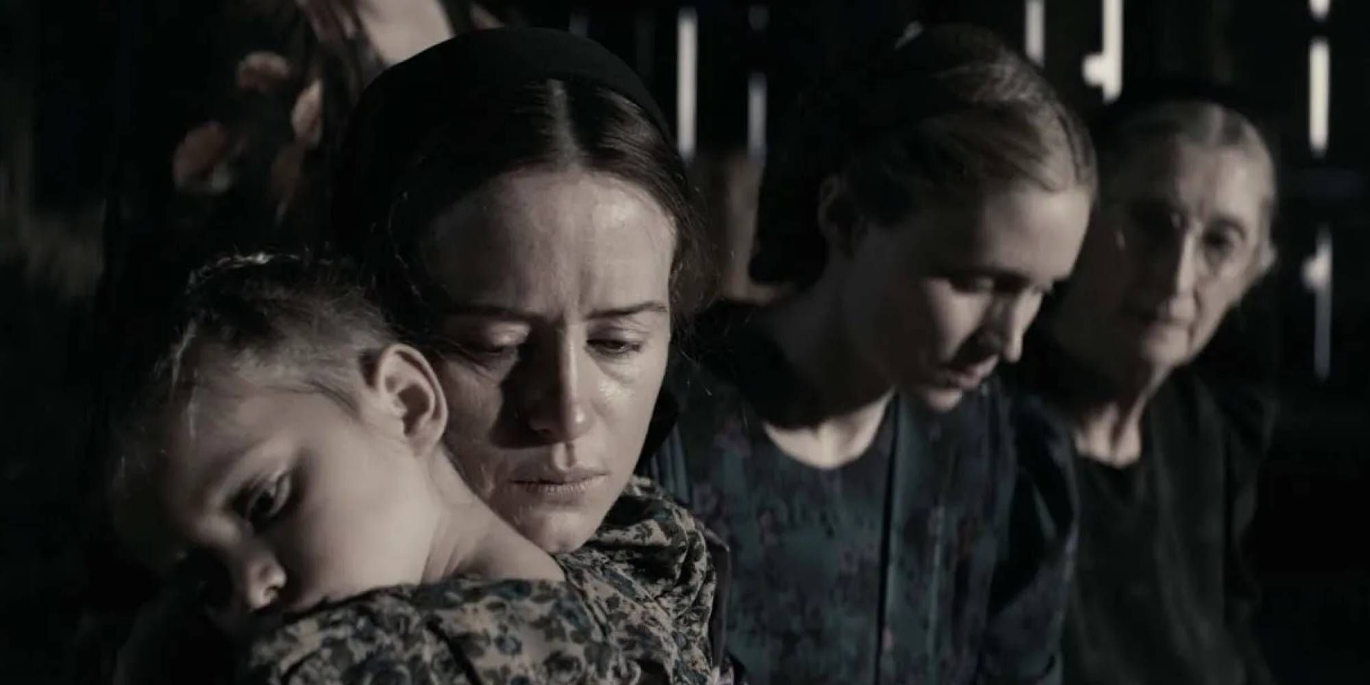 Claire Foy as Salome hugs a child in 'Women Talking.'