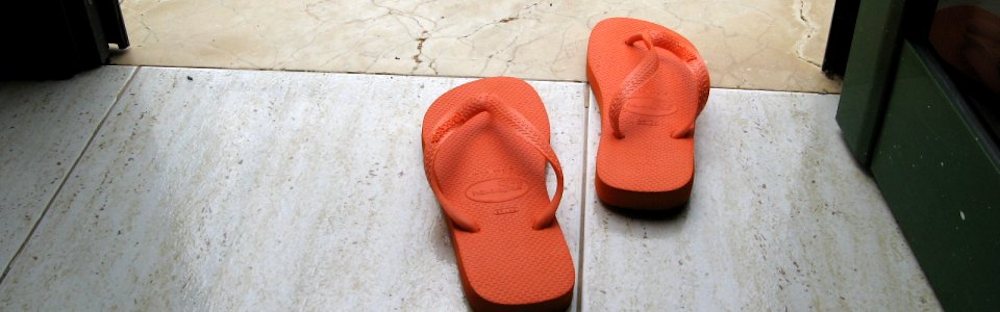 Nicki Hastie's orange flip flops attempting to walk out an open door