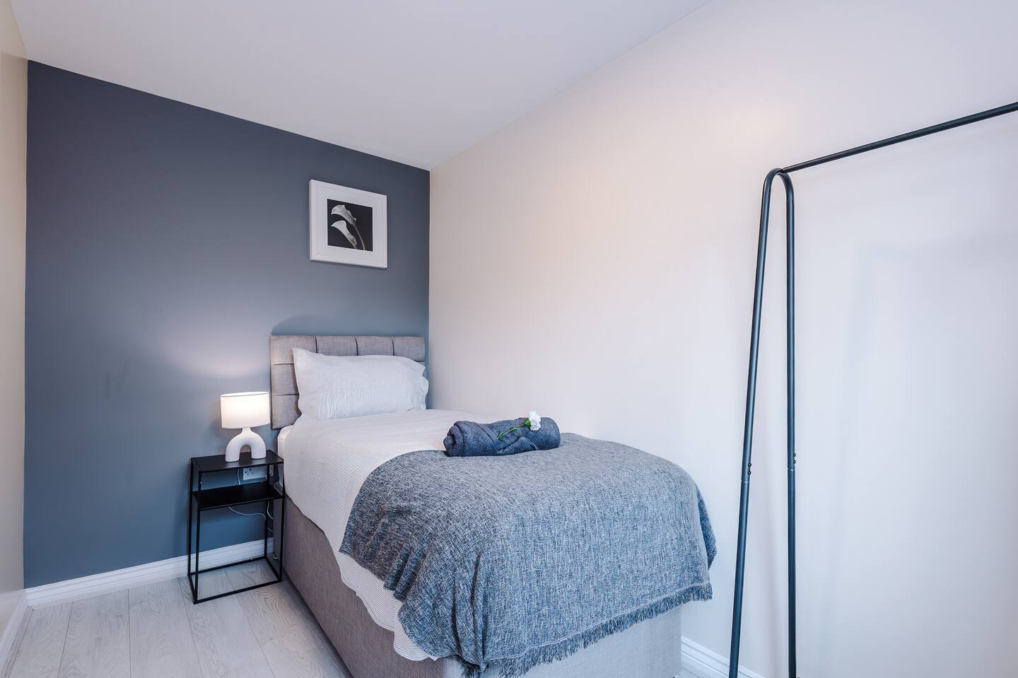 Bedroom 4: Features a large single bed for one person.