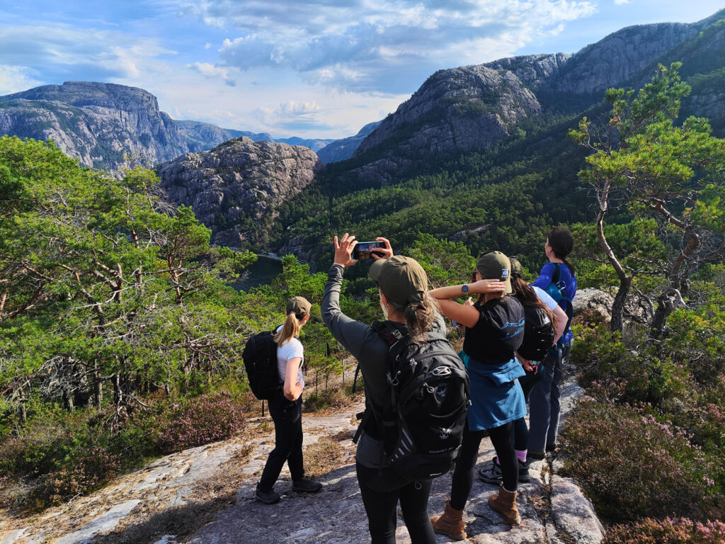 hiking in norway- a group of people roaming the lysefjord mountains
