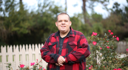 Autistic Adult in front of roses