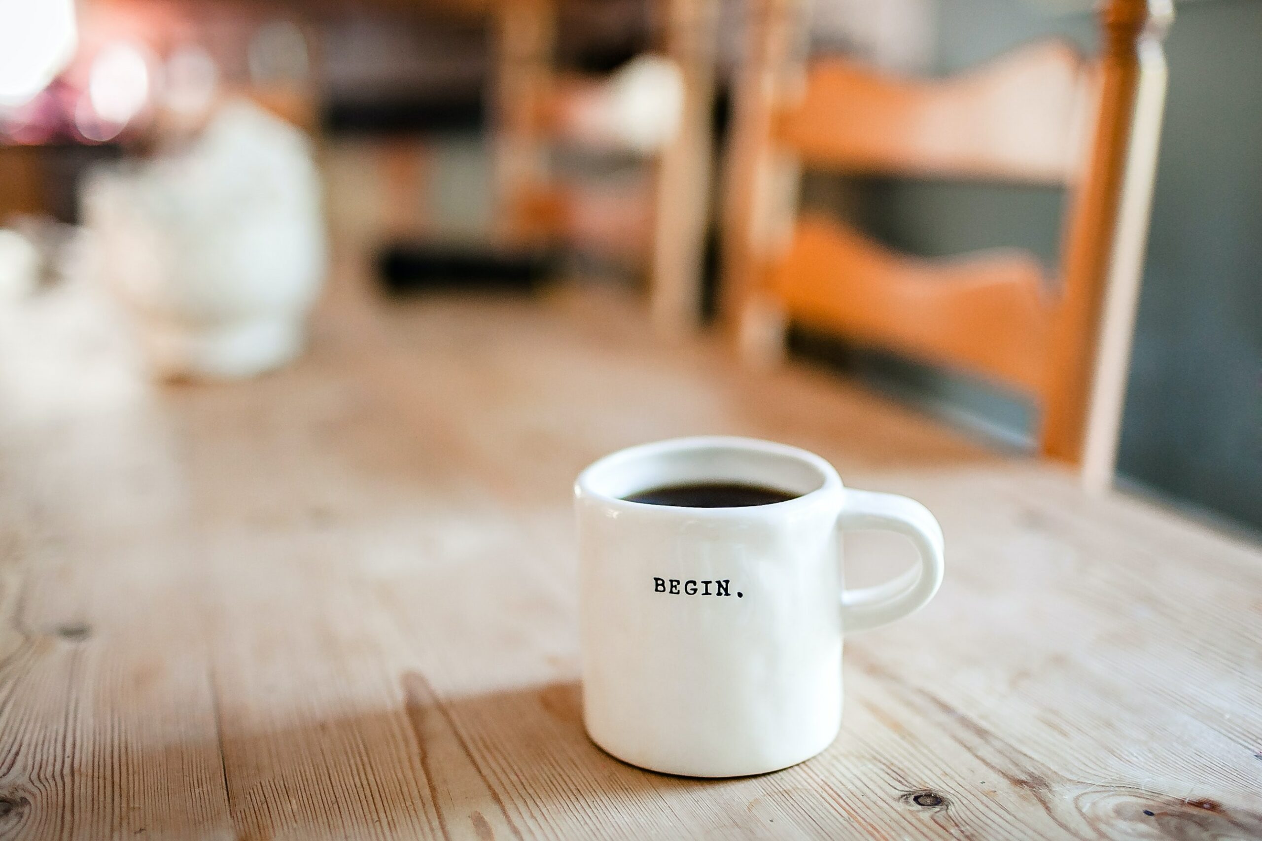 Coffee mug saying 'begin'; Numberslides explains how start-up business financial projections work