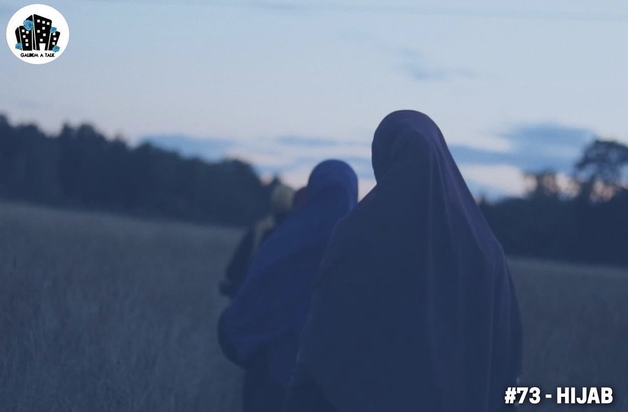 Kvinnor bakifrån i hijab på ett fält