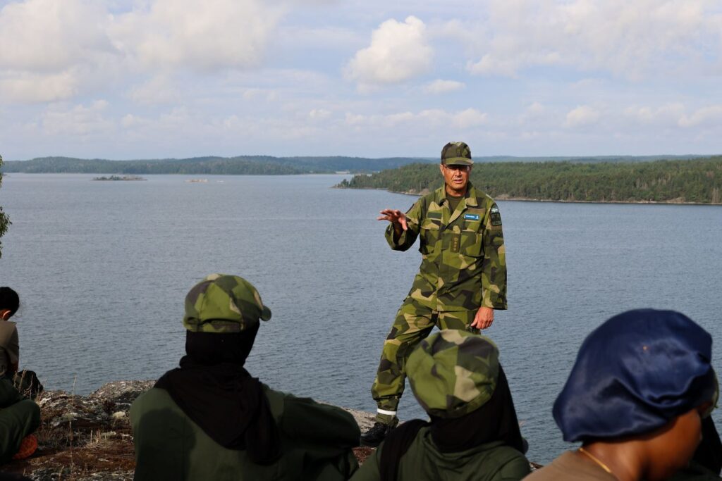 man talar i militäruniform framför 