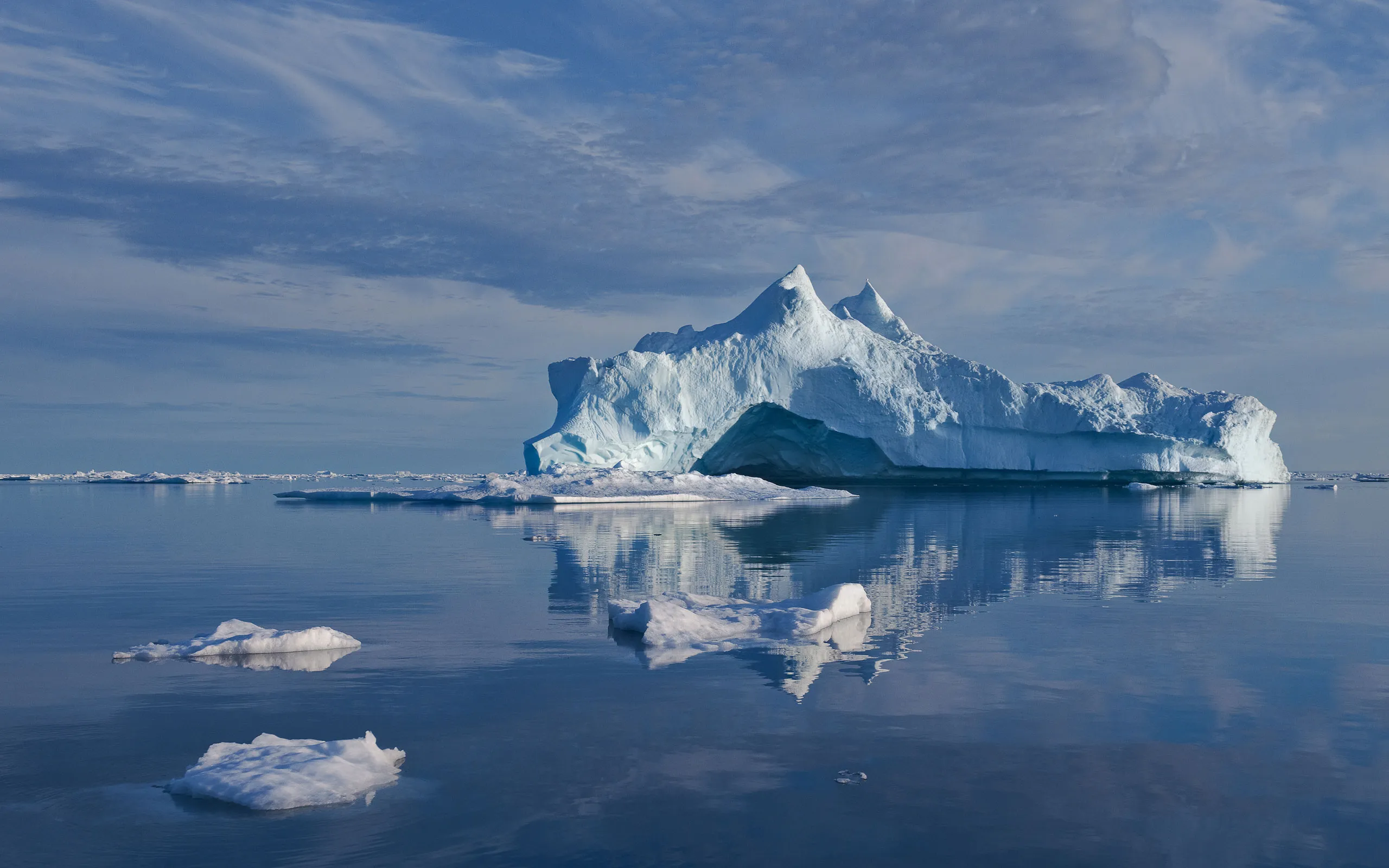 Majestic iceberg reflecting in water.