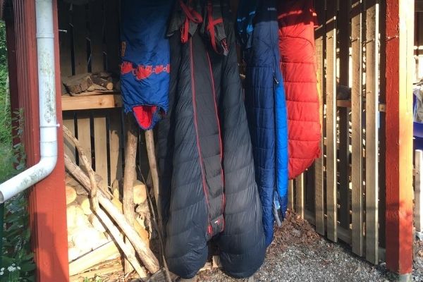 Sleeping bags hanging to dry in a sheltered spot.