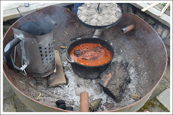 pulled pork over fire in the dutch oven