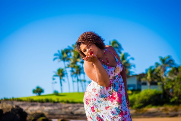 beautiful plus size woman outdoors with a flower dress