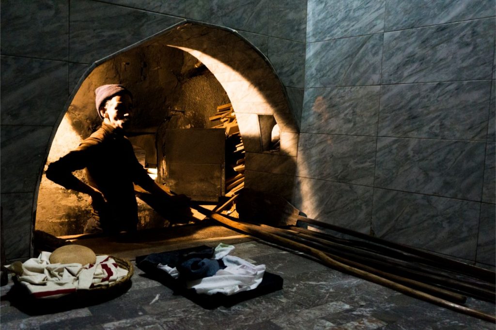 Cooking Moroccan bread in a traditional oven place in Marrakech