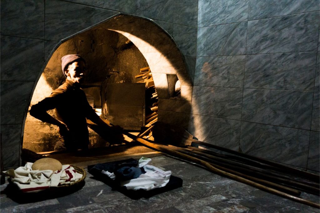 Cooking Moroccan bread in  a traditional oven place in Marrakech