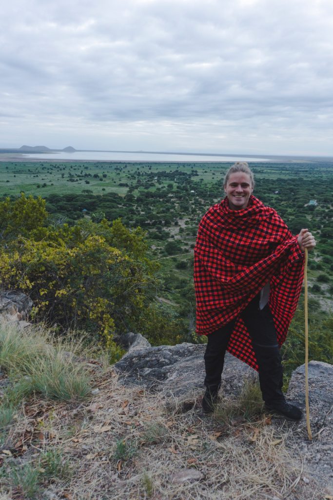 Man with Maasai blanket on top of a hill in Tarangire National Park 