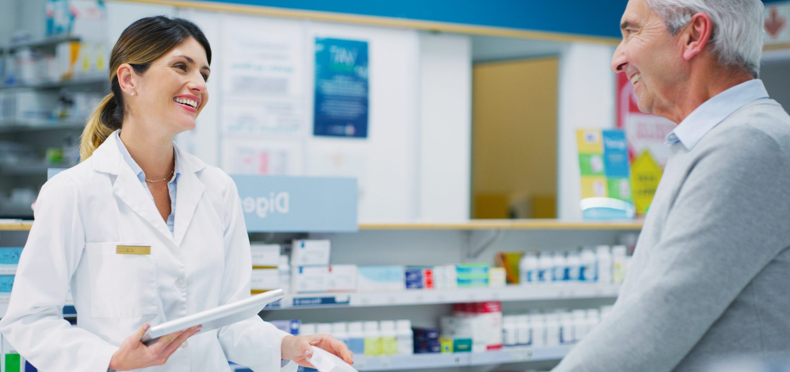 Shot of a pharmacist assisting a customer in a chemist.