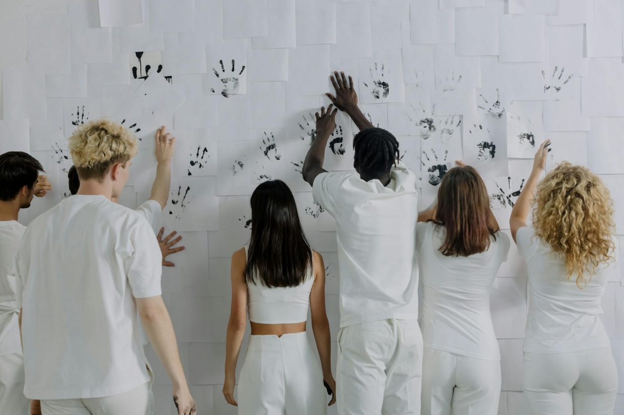 people printing hands on white wall