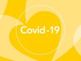 Covid-19 i cirkel med gula hjärtan som bakgrund