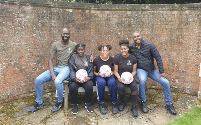 David, Wayne and Kids sitting holding footballs in their hands