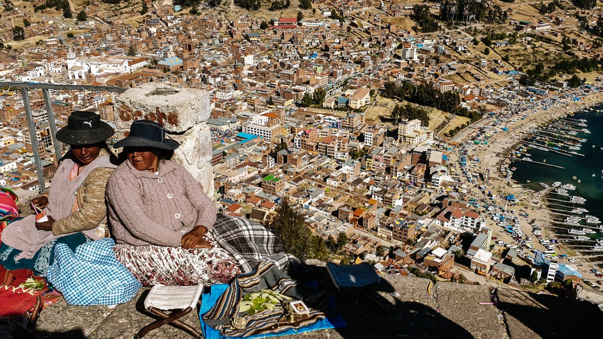women sitting on Cerro Calvario during Independence Day, one of the best things to do in Copacabana Bolivia
