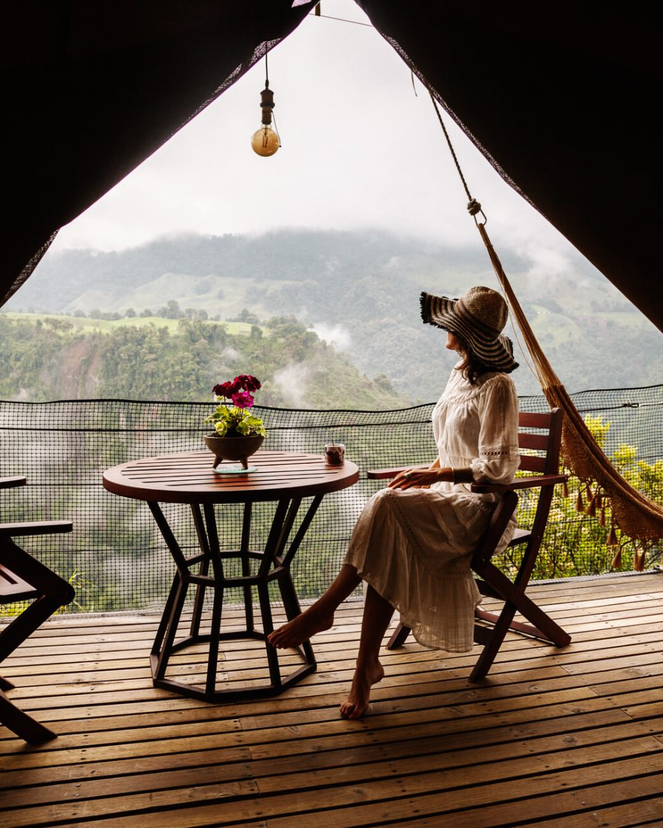 deborah on balcony with incredible view of valley in El nido del condor Colombia