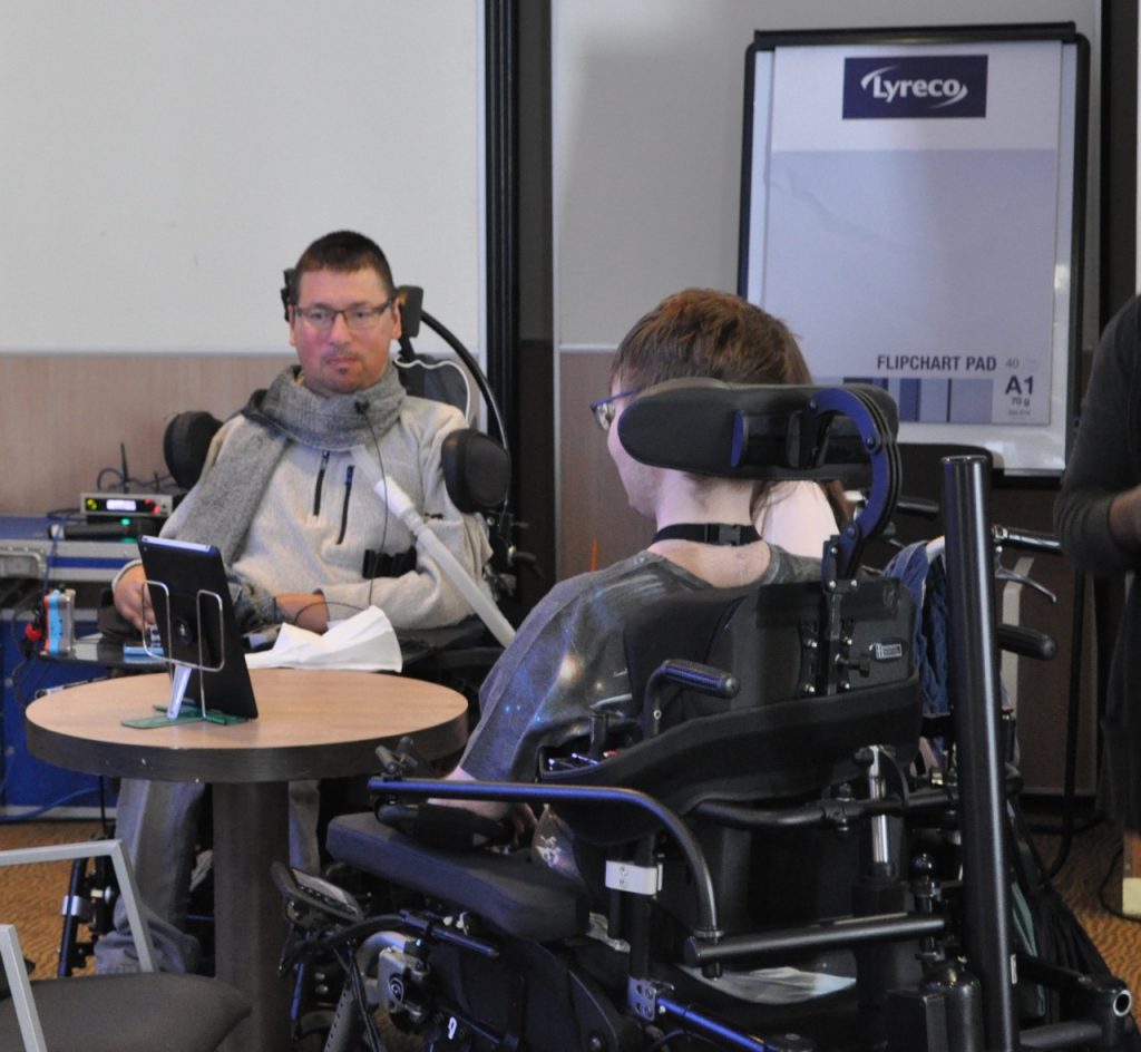 Mark Chapman and another electric wheelchair user in conversation