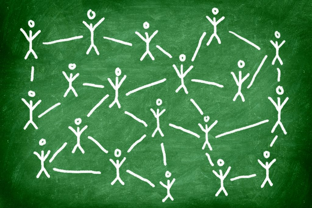 A green background with a number of white stick figures painted on. The stick figures are spread evenly, and in between each gap is a short white line.