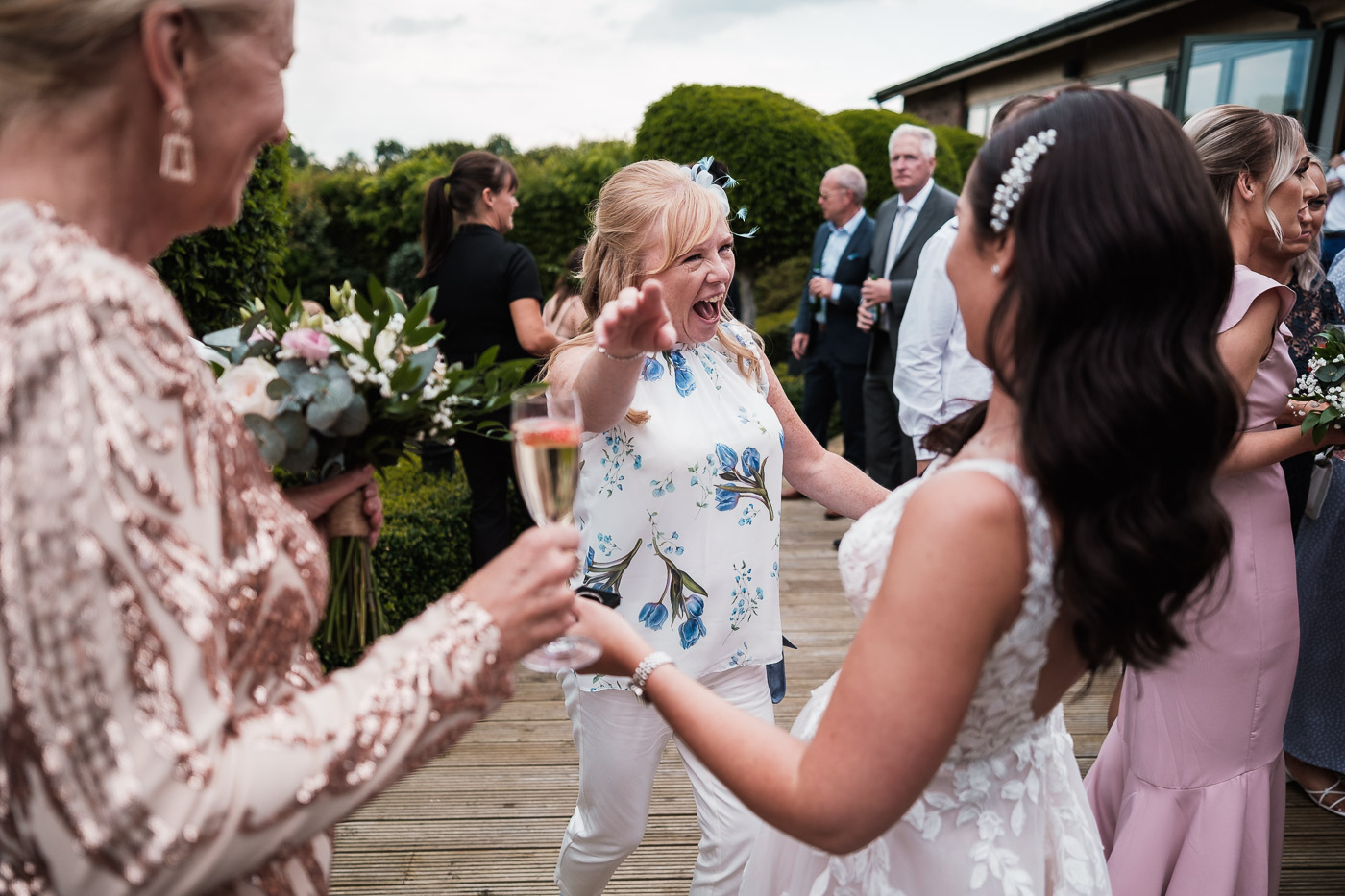 bride is embraced by an excited mother of the groom on their wedding day at Pryors Hayes in chester