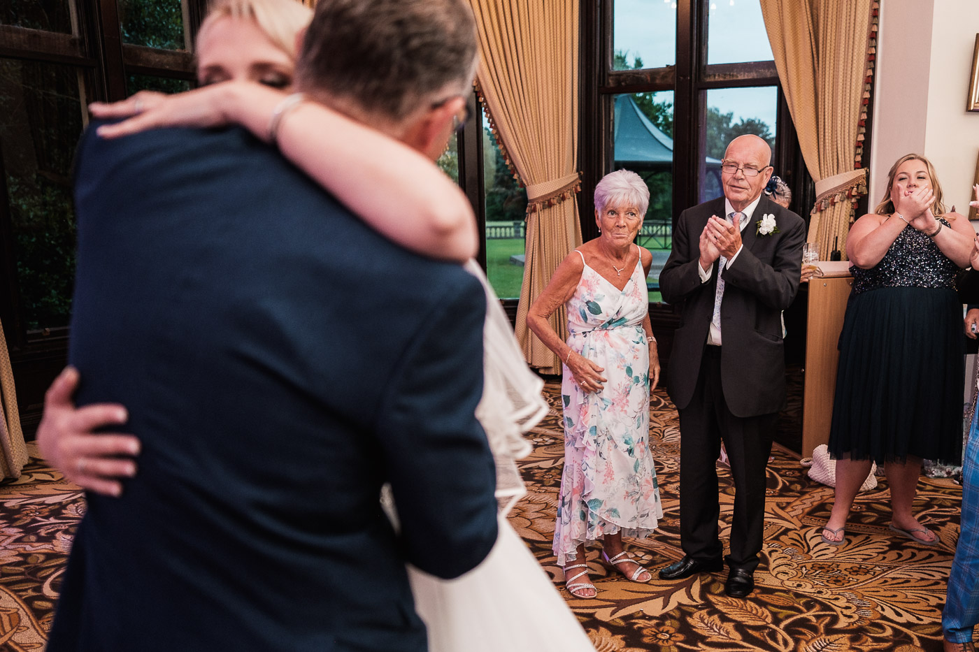 grooms parents watch the first dance with dj playing at Walton hall