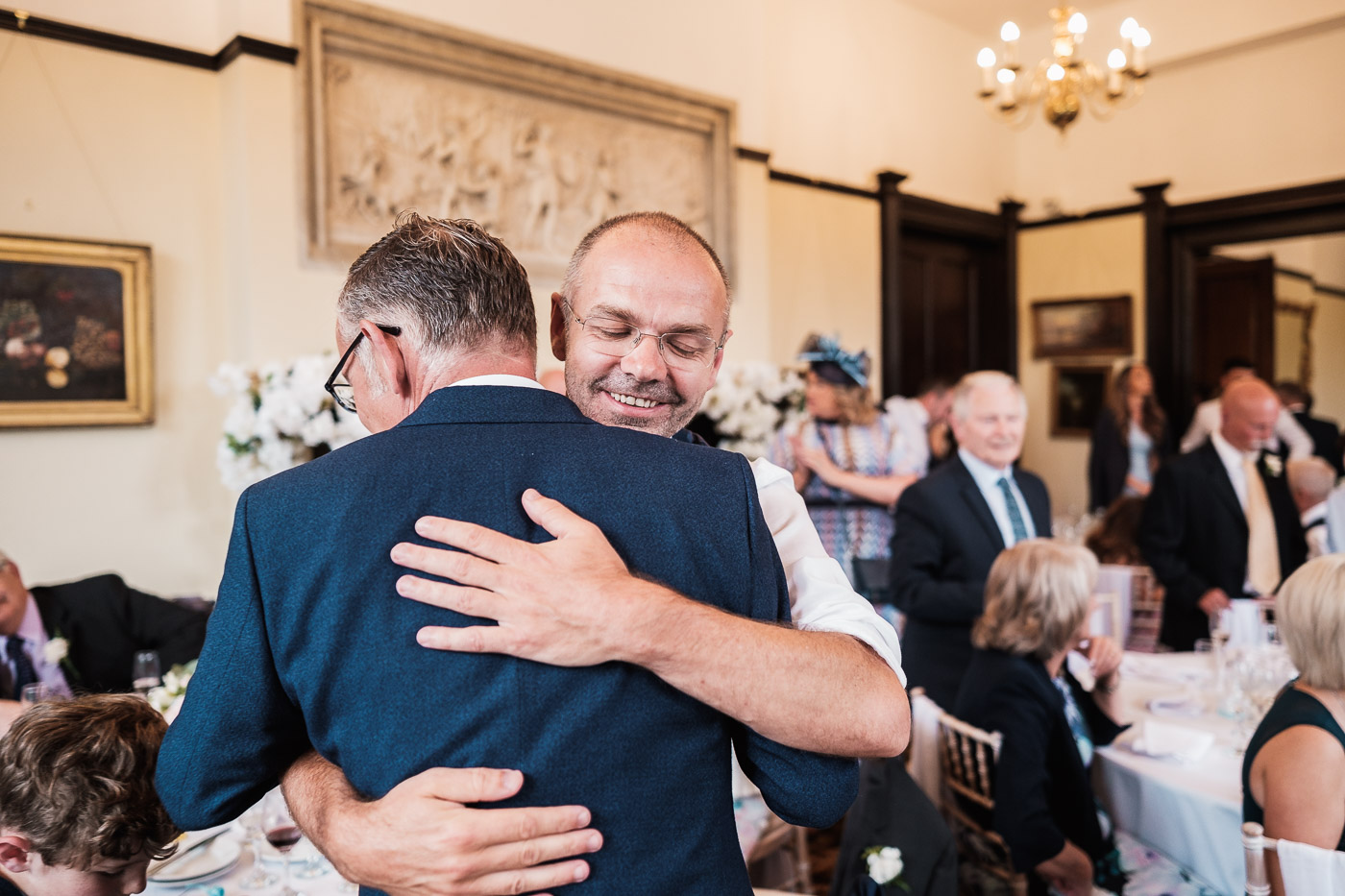 Groom embraces best man after speeches at Walton hall in warrington