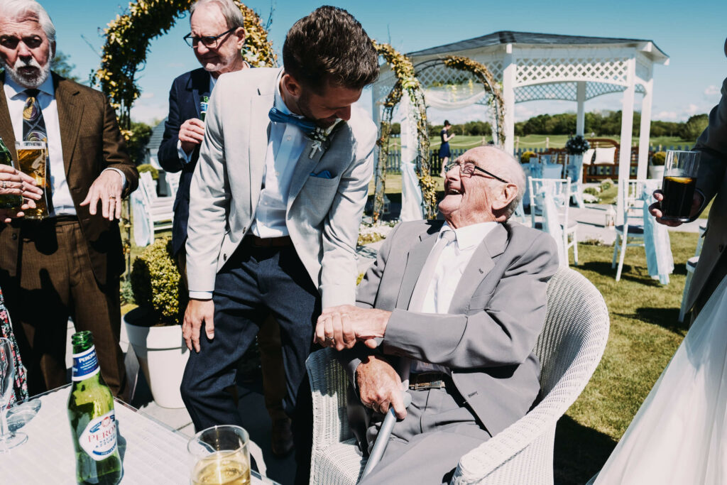 candid photograph at wedding with grandad