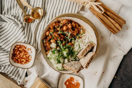 Foto van vegetarische curry met kruiden er rond.