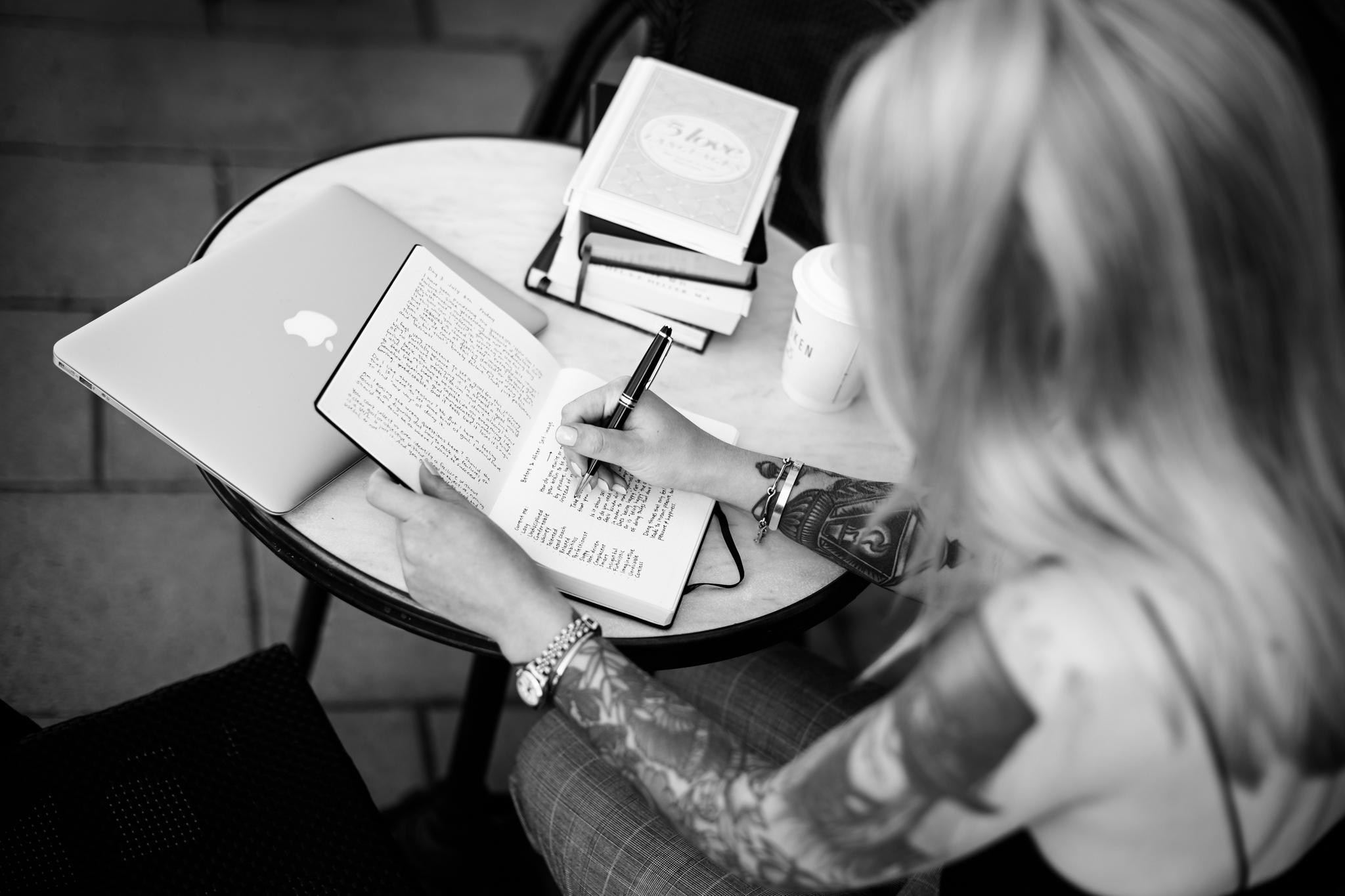 Black and white photo of coach Katrin Berndt writing in a notebook