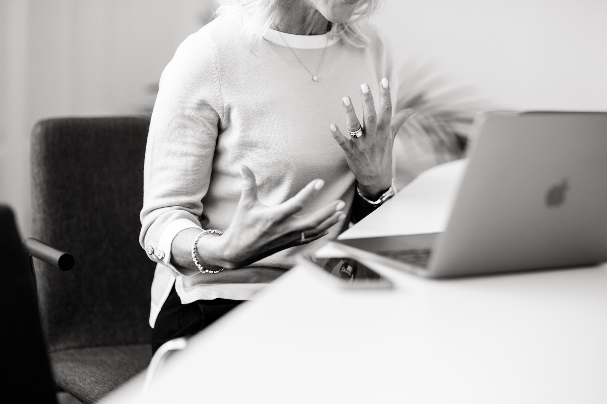 a black and white photo of executive coach Malin Hedlund as she's gesturing with her hands