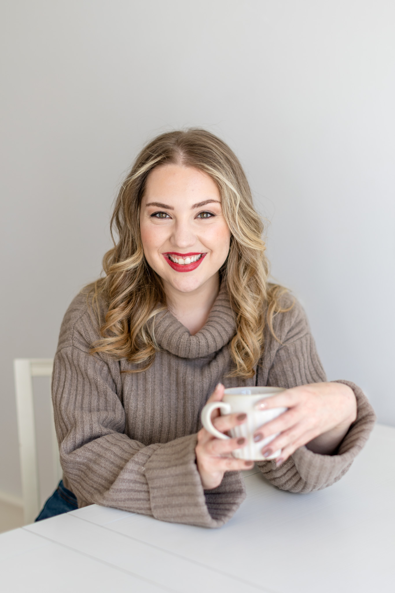 a photo of copywriter Megan Taylor holding a cup of coffee and looking into the camera smiling
