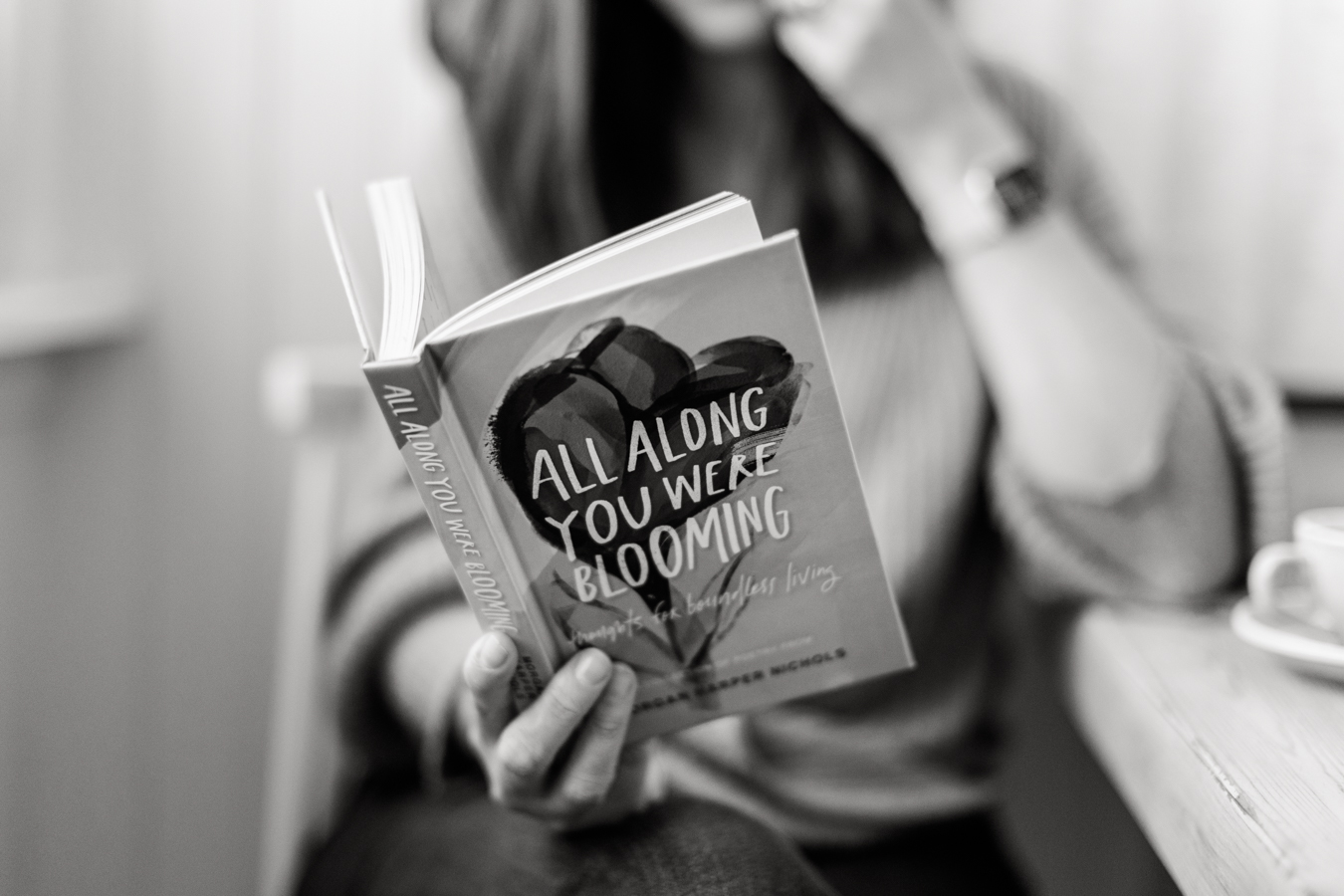 220509-Lumeah-Brand-Photography-001-6 a black and white photo of a woman reading a booked called 'Alla long you were blooming'