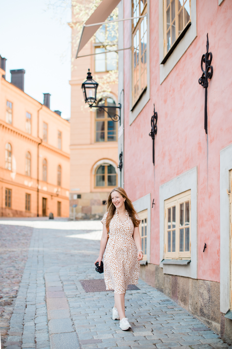 a colourful brand photo of personal brand photographer Emma Jackson on Riddarholmen in Stockholm