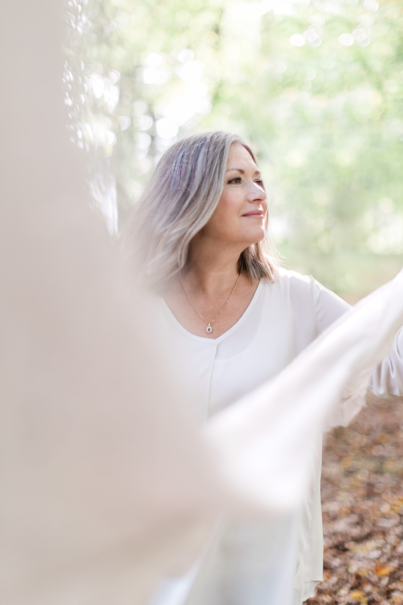 a brand photo of coach Agneta Ritums in a forest with a scarf