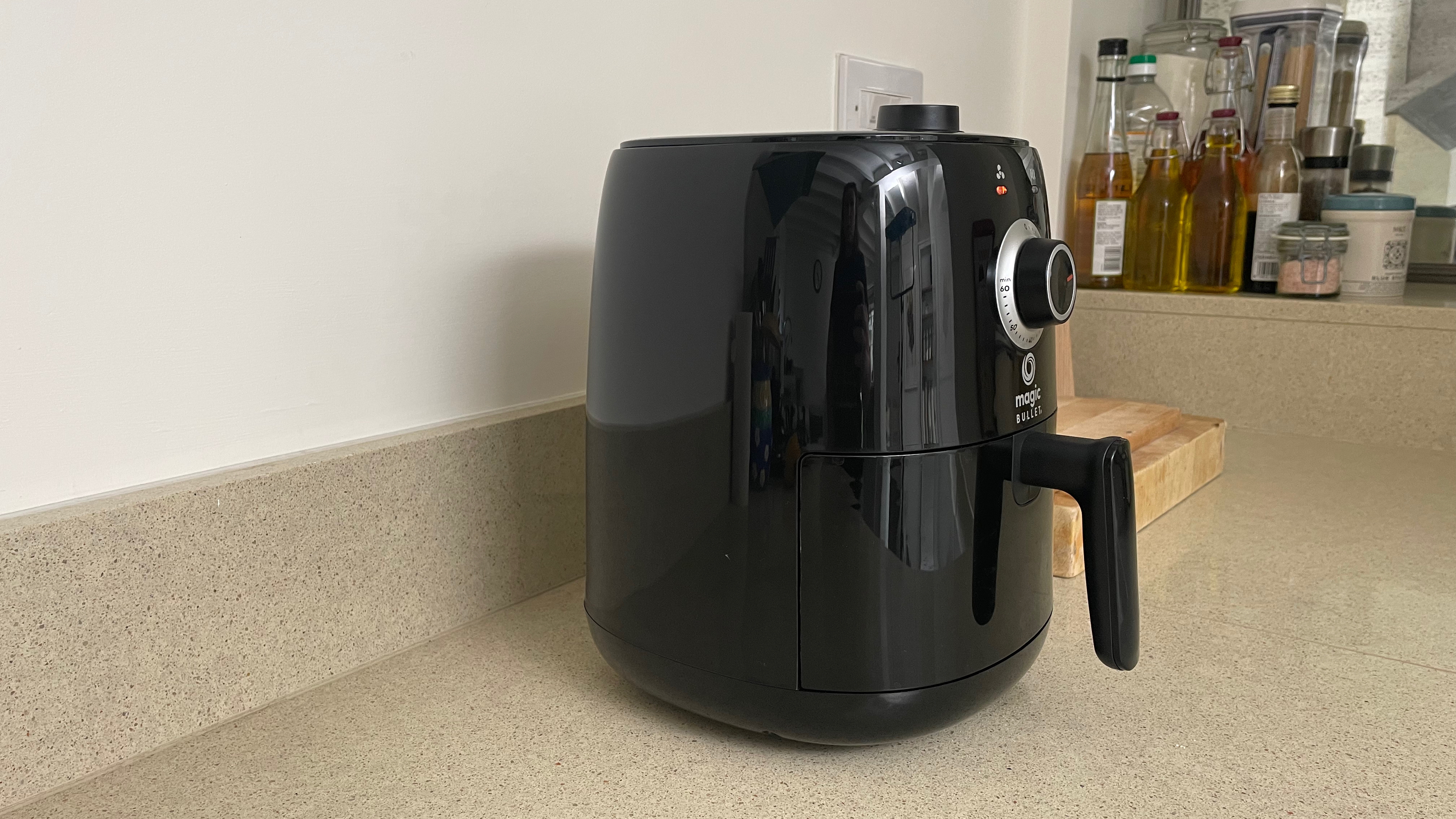 Magic Bullet Air Fryer on a kitchen counter, side view
