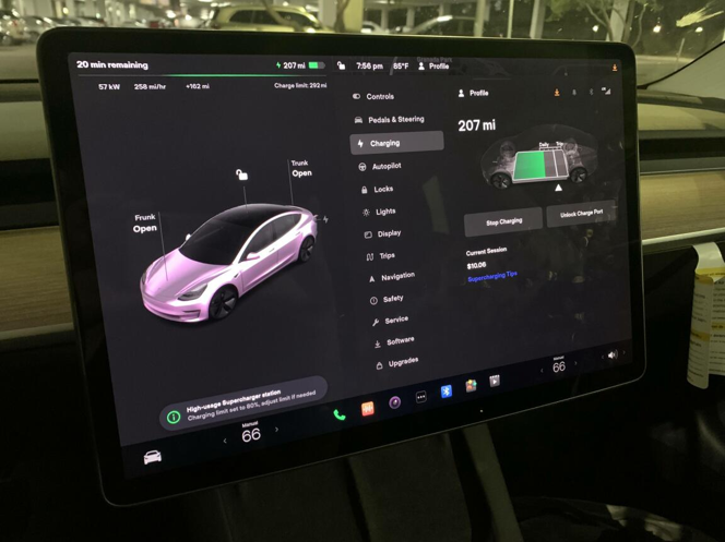The internal screen on a Tesla Model 3 showing charging progress 