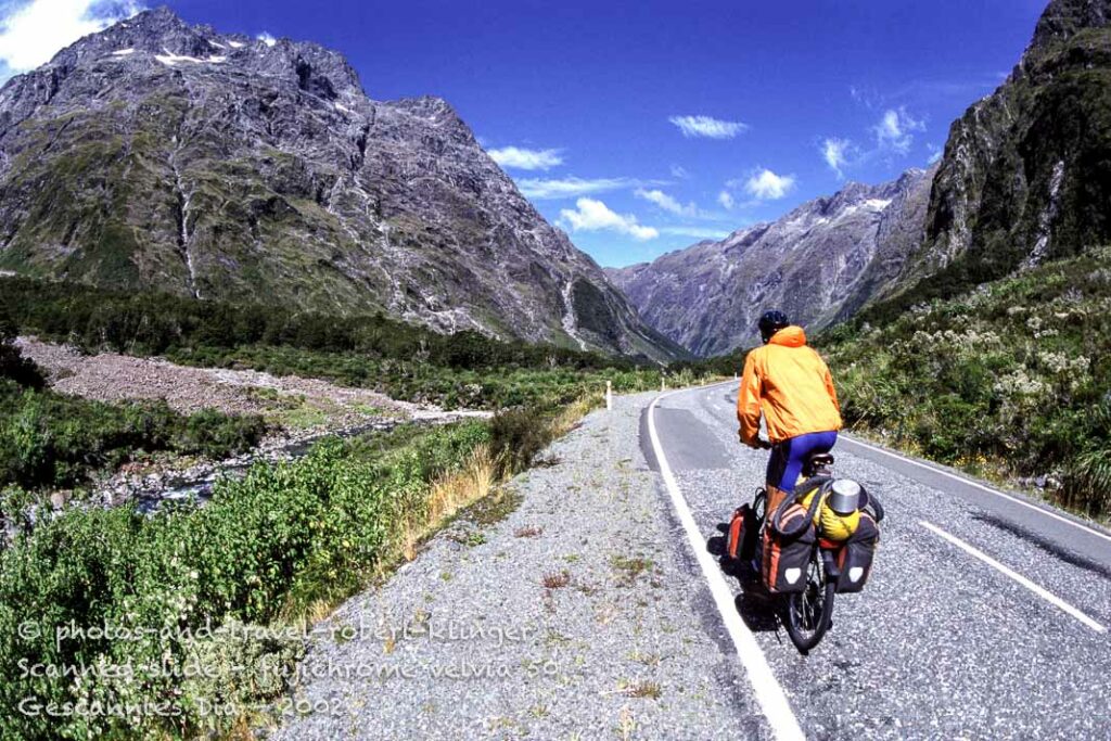 A cyclist riding on the Milford road to Milford Sound