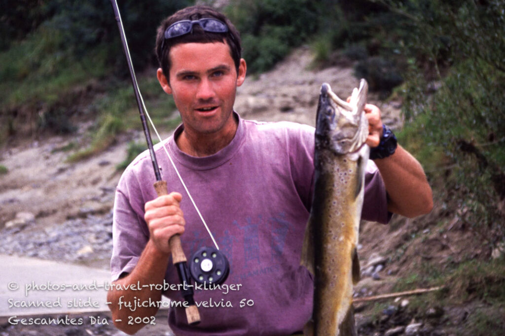 A flyfisherman and a brown trout in New Zealand