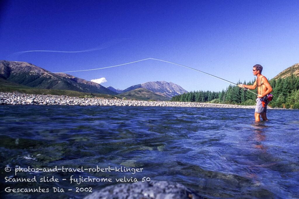A flyfisherman casting a line on the Wairau river, New Zealand