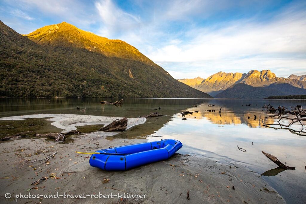 A packraft on the shoreline of Lake Te Anau, New Zealand