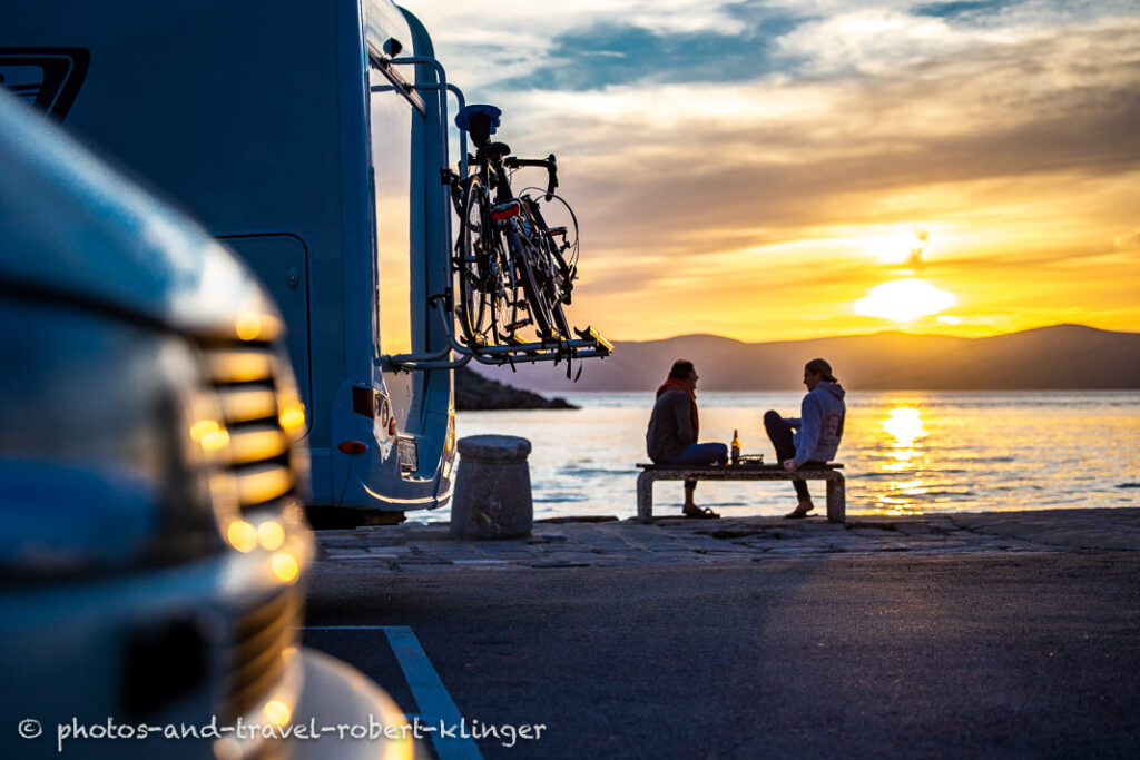 A young couple enjoying a beer in the harbour of Sveti Juraj in Croatia