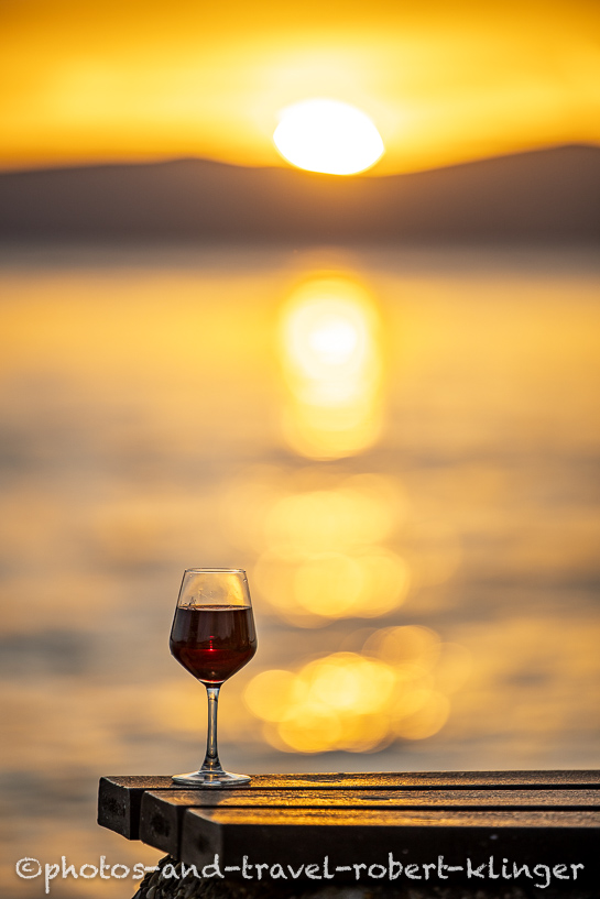 A glass of wine during sunset in Sveti Juraj, Croatia