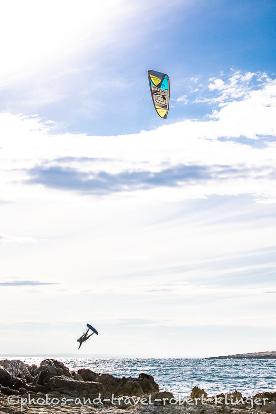 A kitesurfer is jumping over the sea close to Liznjan, Croatia