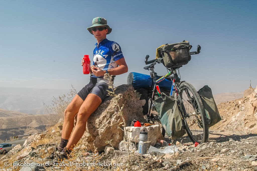 A cyclist is having a rest in the Andes in Peru