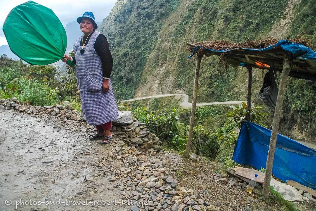 A woman controlling traffic on North Yungas Road