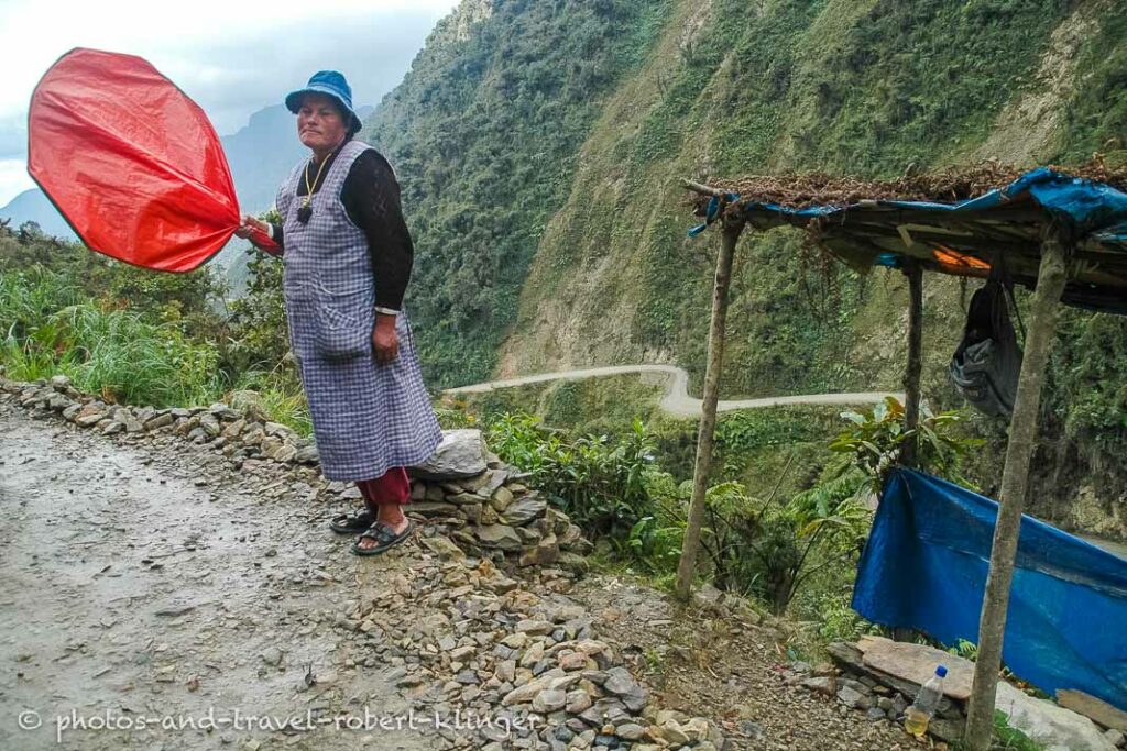 Woman controlling traffic on Yungas Road